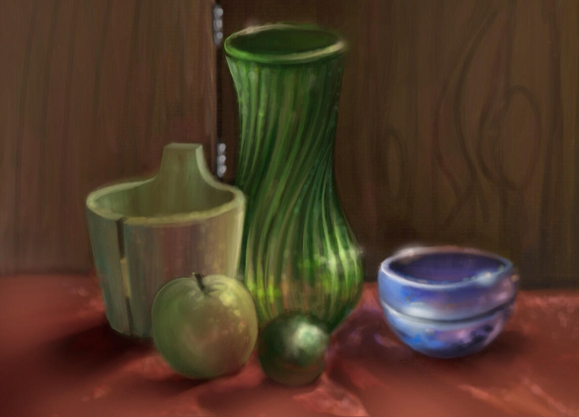 A still life of two glass pieces, a wooden basket, an apple, and a lime done in a dimly lit classroom.